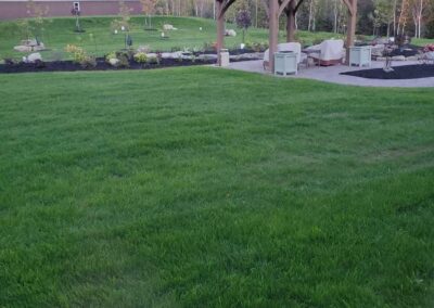 Open lawn with a gazebo and young landscaping beds